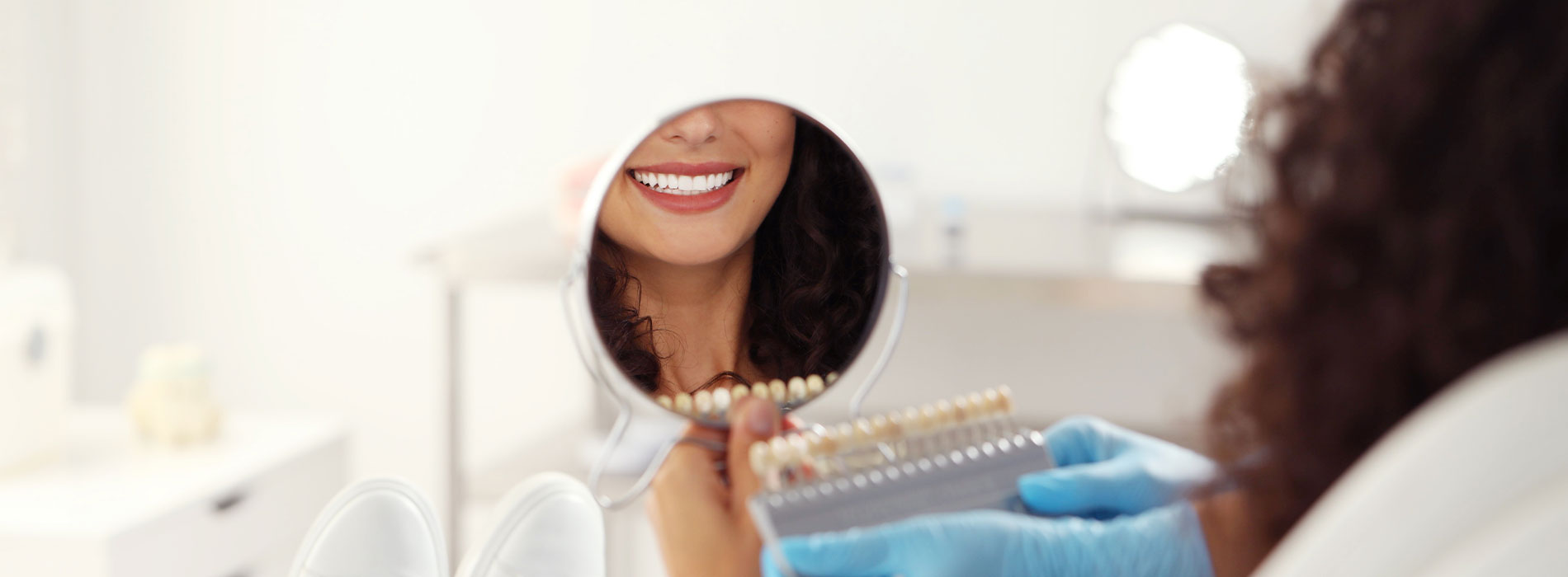 A person sitting at a desk with a magnifying glass, examining something on a microscope slide.