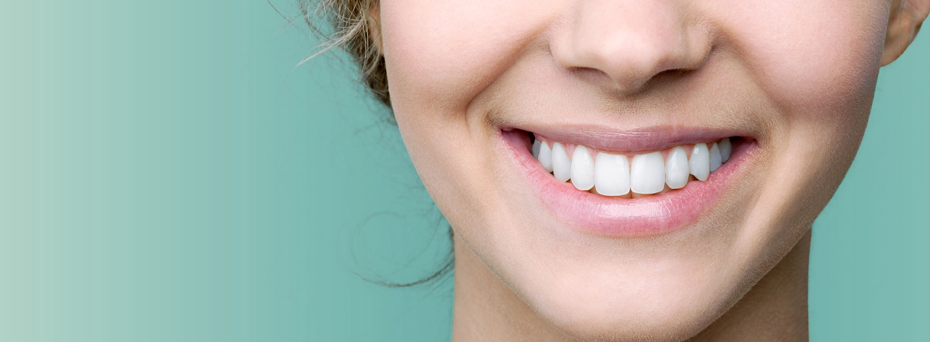 The image shows a close-up of a person s smiling face with teeth, set against a bright blue background.